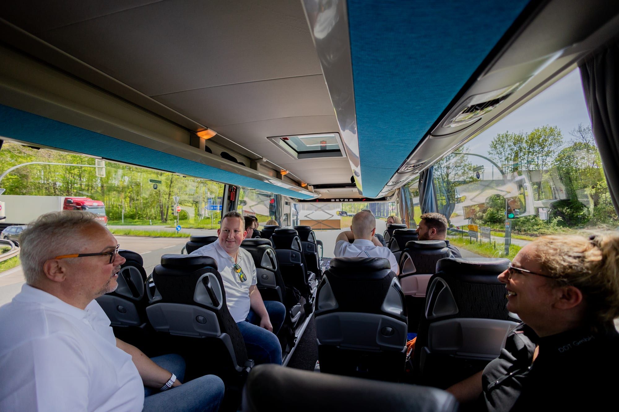 Colleagues on the coach on the way to the celebration