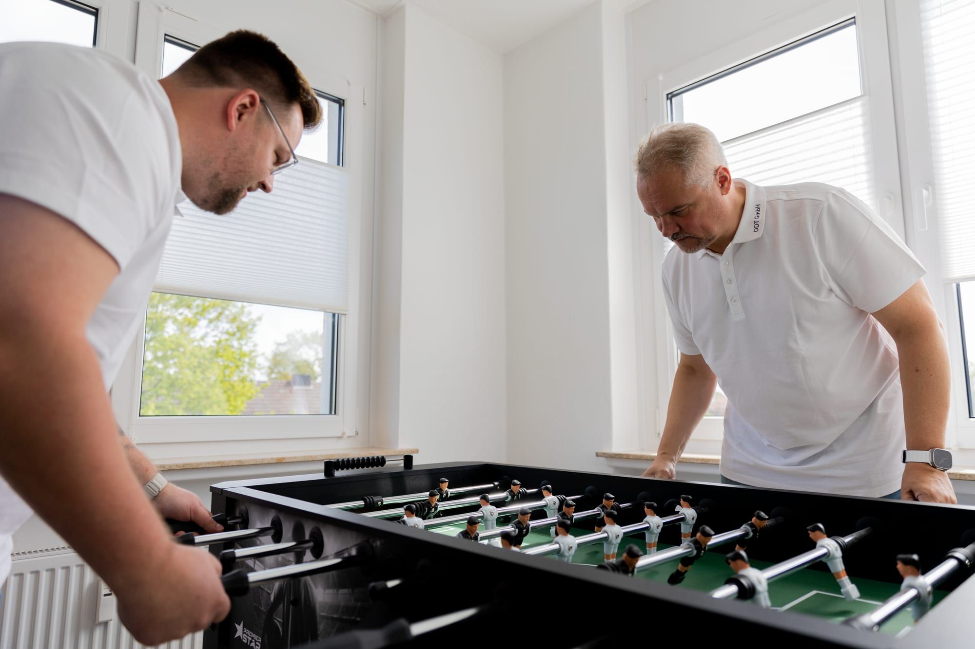 Two colleagues at the table football in the office